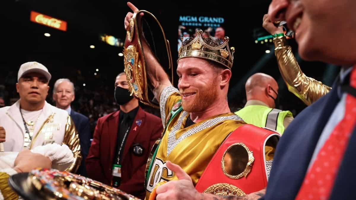 Canelo celebrates with crown and belts