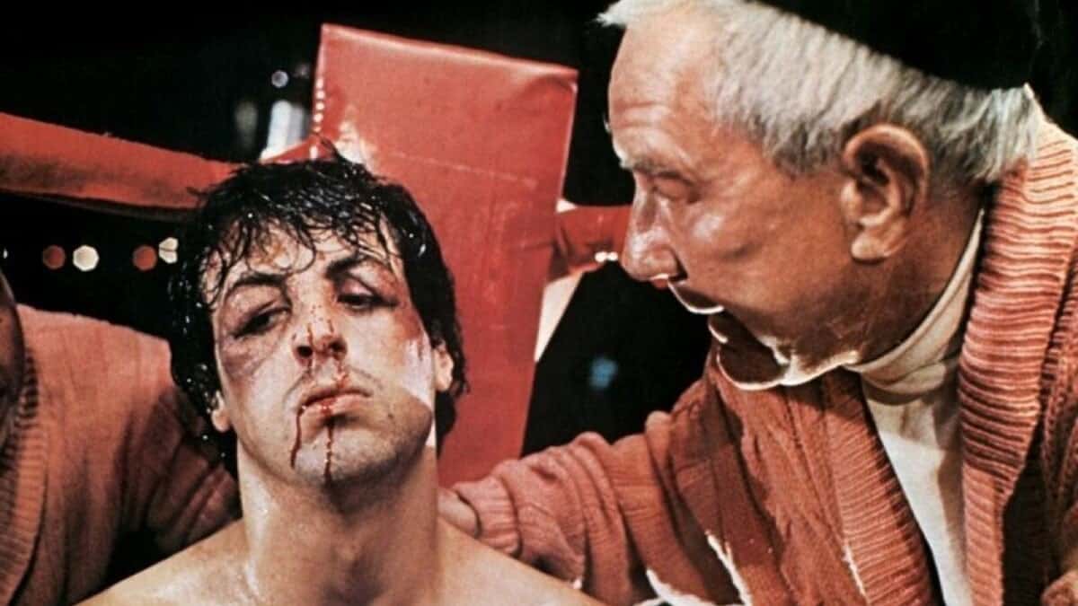 Sylvester Stallone as Rocky Balboa and Micky Goldmill