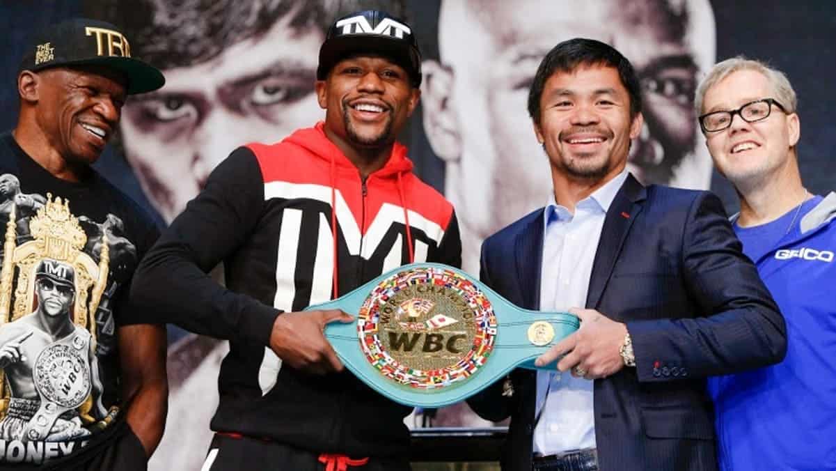 Floyd Mayweather and Manny Pacquiao holding WBC championship belt during previous bout