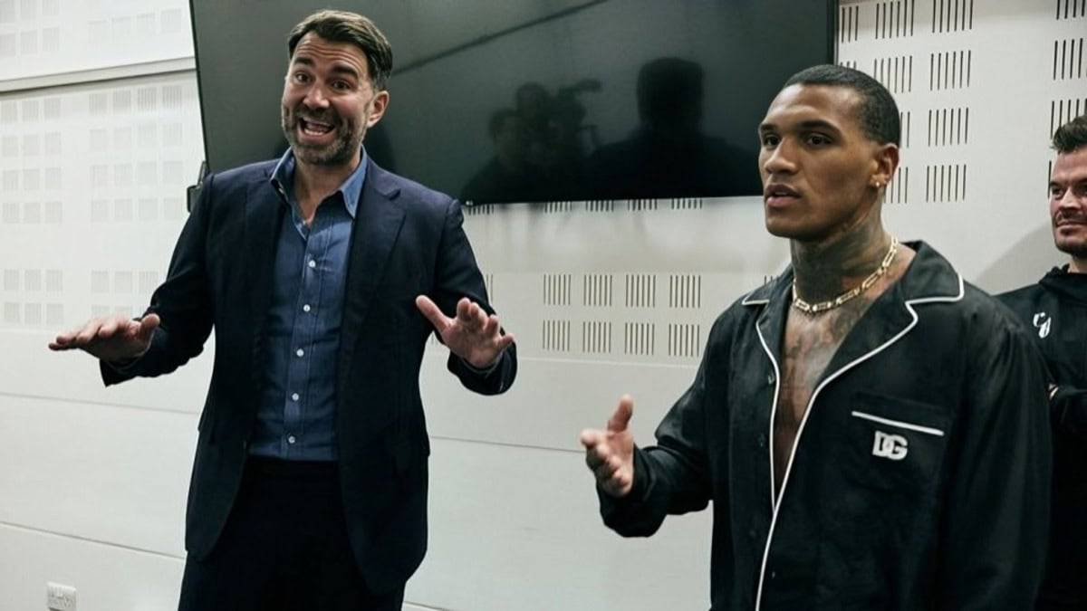 Eddie Hearn and Conor Benn speaking backstage during media appearance