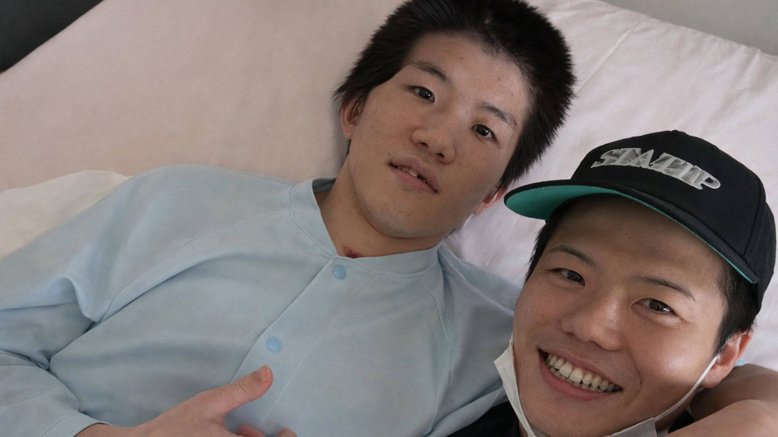 Ginjiro Shigeoka in hospital bed during recovery from brain injury with brother Yudai