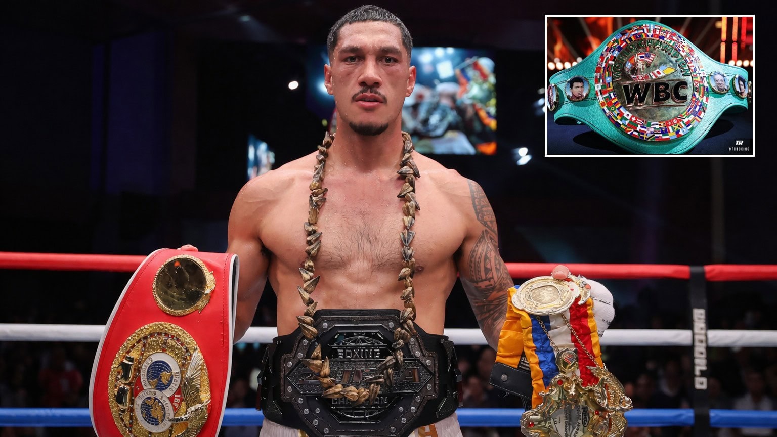 Jai Opetaia holding championship belts with the WBC cruiserweight title belt inset