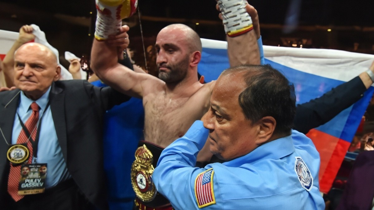 Murat Gassiev celebrates victory while wearing the WBA Regular heavyweight title belt