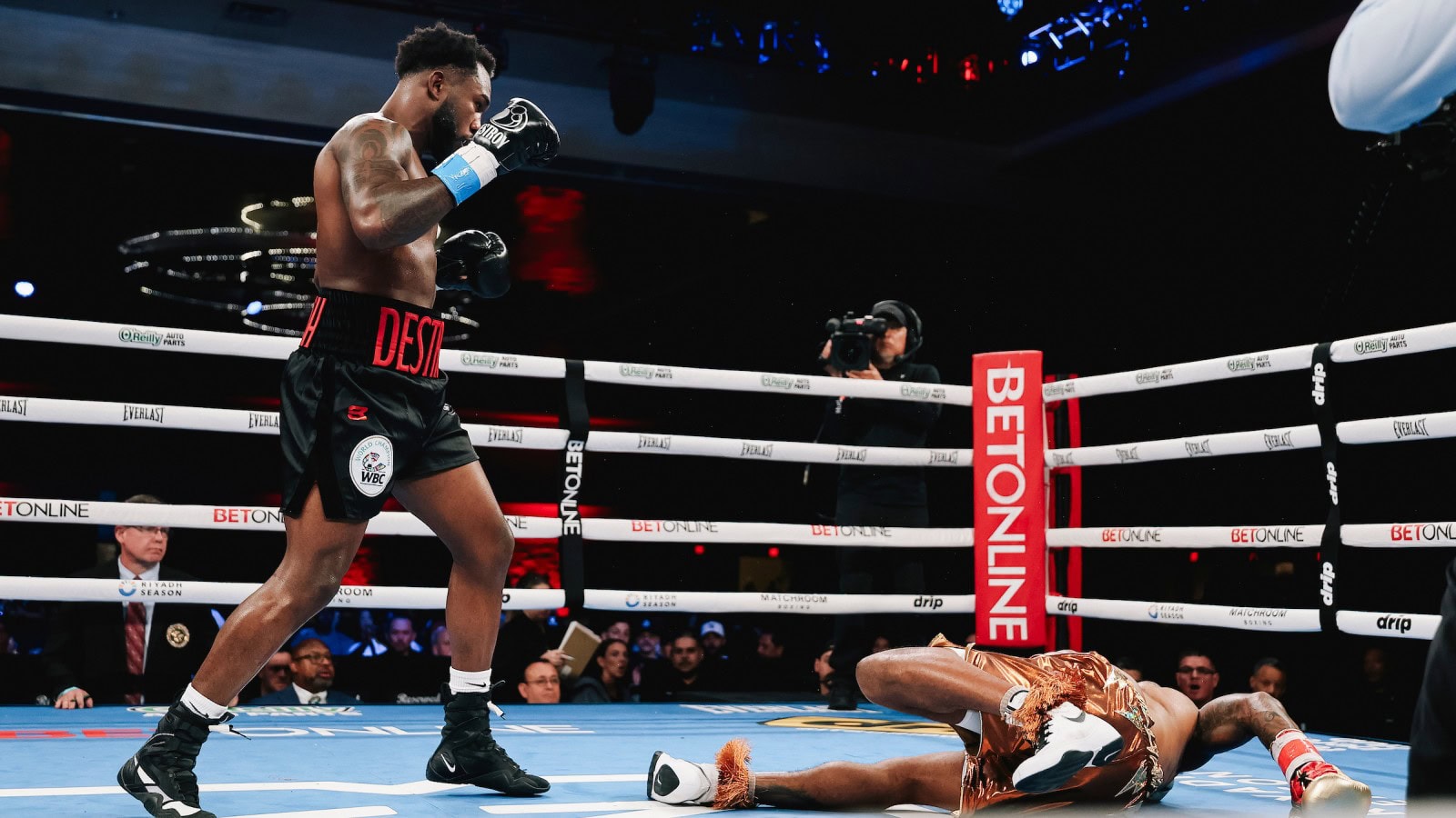 Carlos Adames drops Austin Williams during their WBC middleweight title fight in Orlando