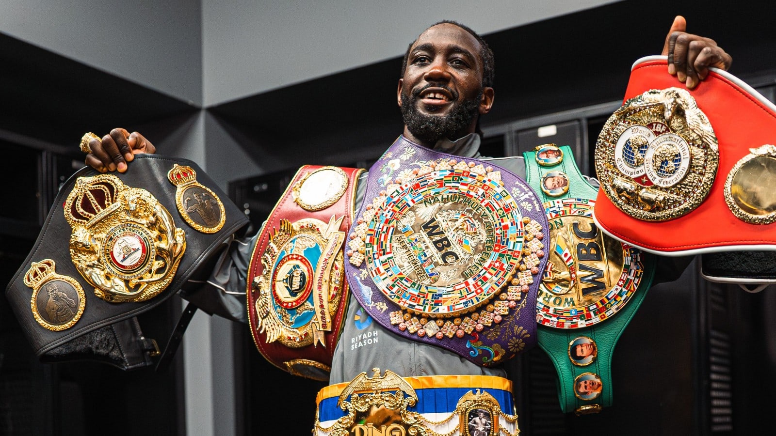 Terence Crawford holding multiple world championship belts during his undisputed reign