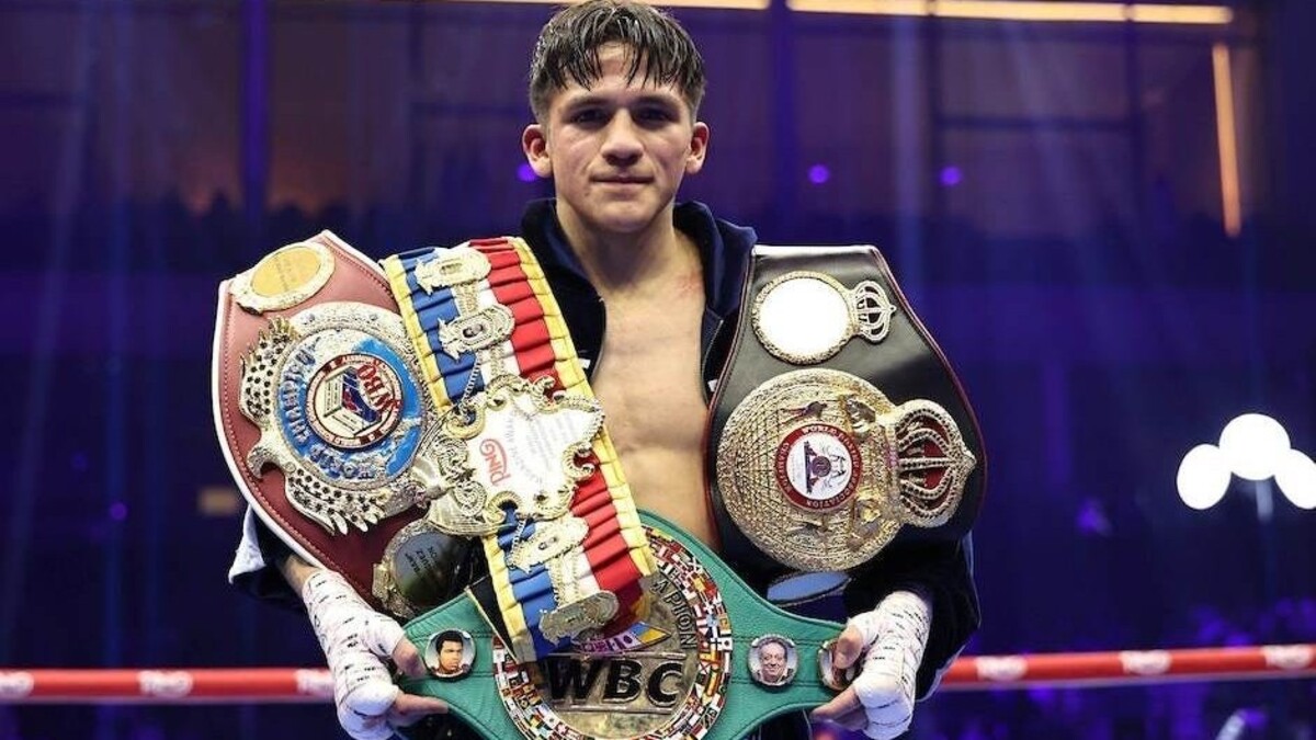 Jesse Rodriguez holding multiple world title belts after victory