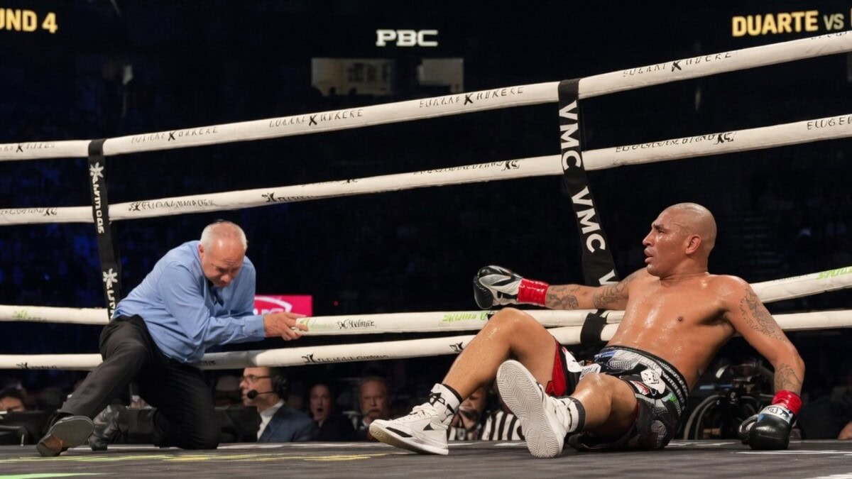 Angel Fierro sits on the canvas as referee Mark Nelson falls during their super lightweight fight at T-Mobile Arena, Las Vegas.
