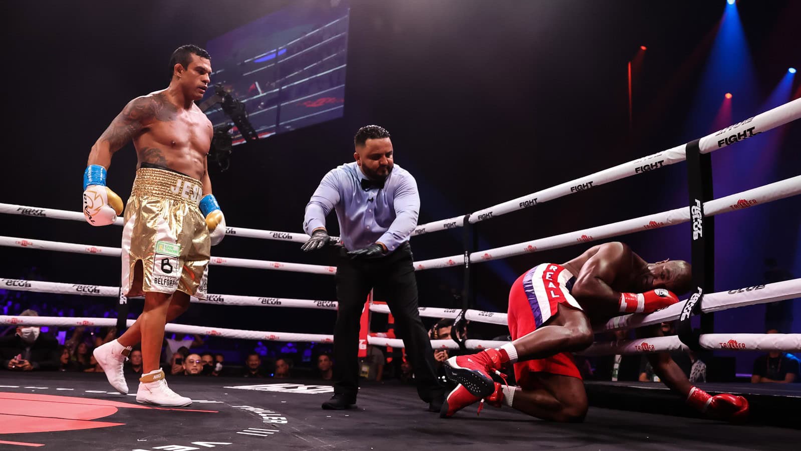 Evander Holyfield is down against the ropes after being stopped by Vitor Belfort during their exhibition fight.