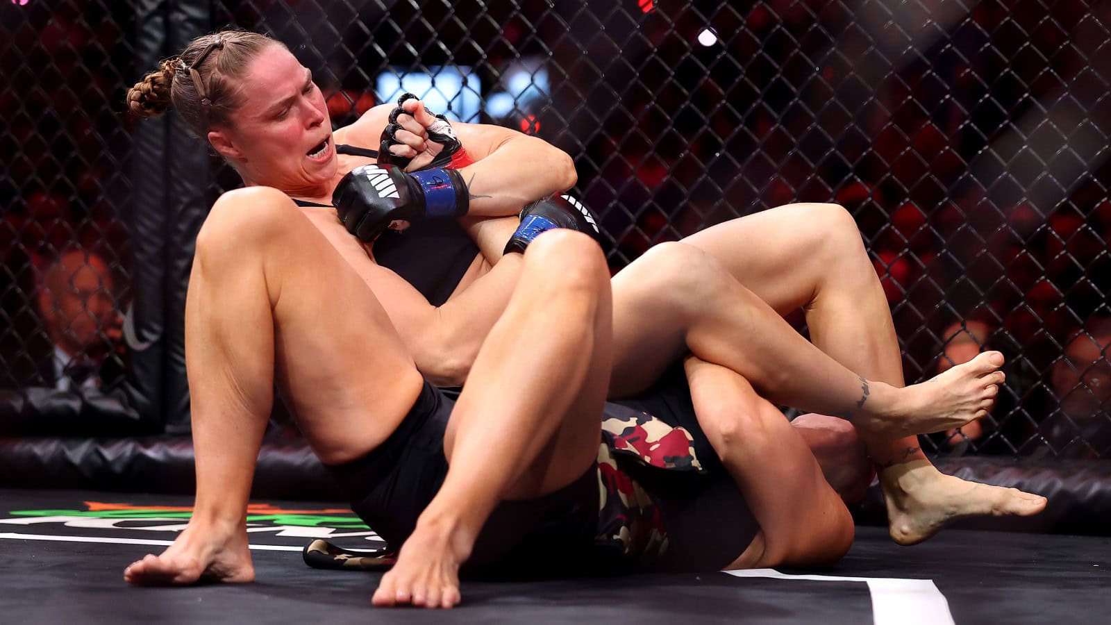 Ronda Rousey locks in an armbar submission against Gina Carano during MVP MMA’s debut Netflix event.