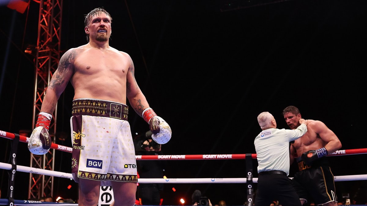 Oleksandr Usyk stands in the ring after the controversial late stoppage of Rico Verhoeven in round eleven as referee Mark Lyson waves off the heavyweight title fight in Egypt