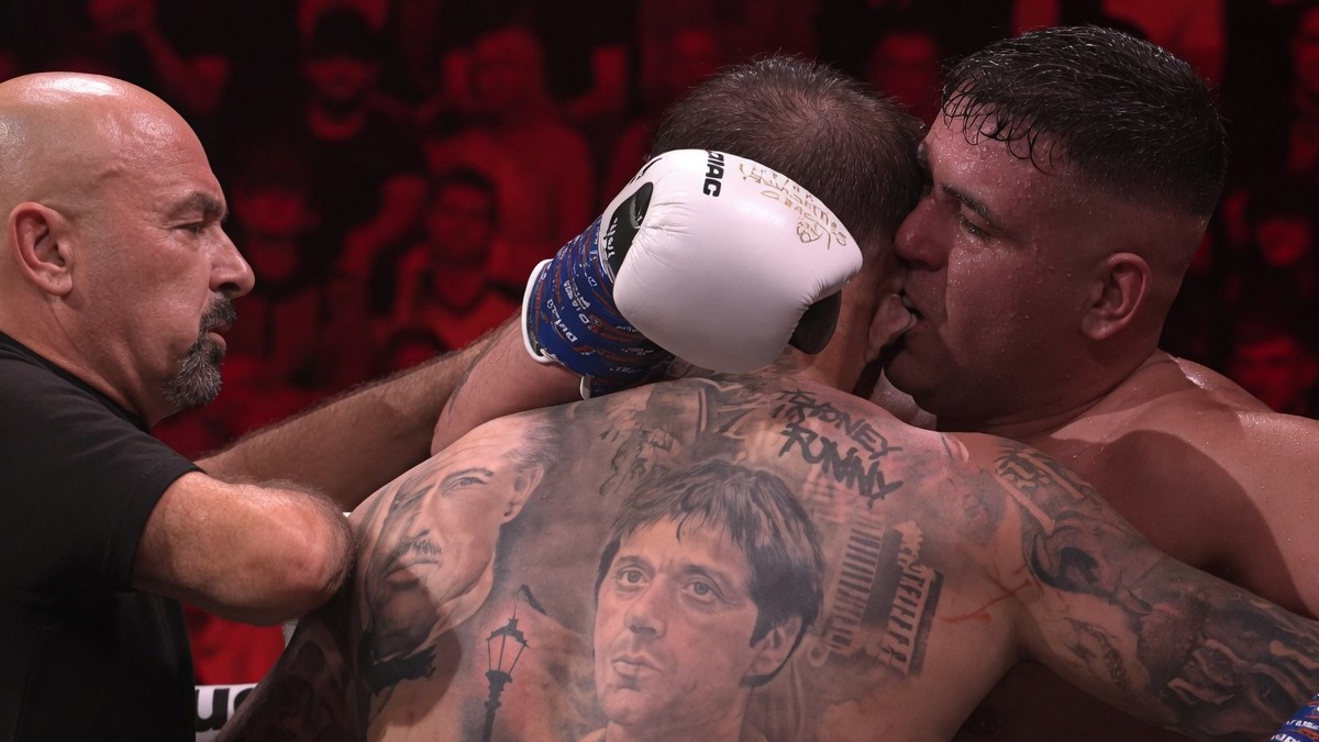 Boxer appears to bite his opponent during a chaotic bout as a referee intervenes at a controversial combat sports event broadcast on DAZN