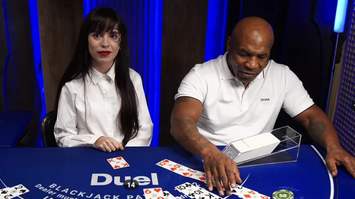 Mike Tyson sits at a Duel Casino blackjack table beside a female card dealer during a viral livestream that sparked widespread online discussion