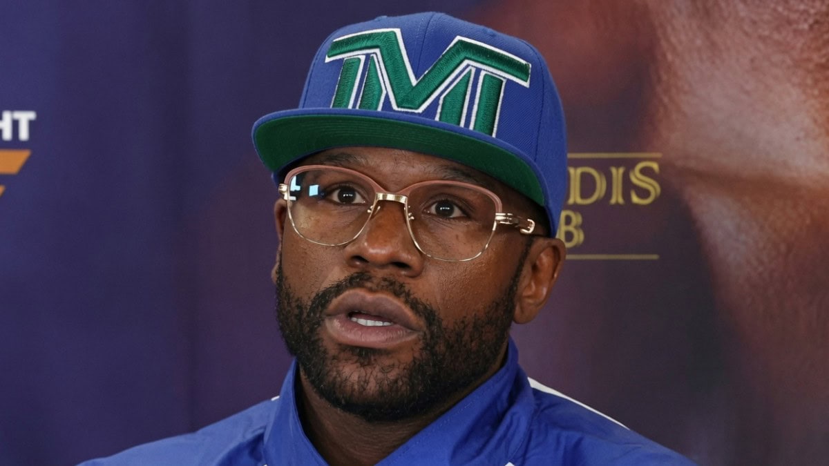 Floyd Mayweather wearing a TMT cap and glasses during a media event