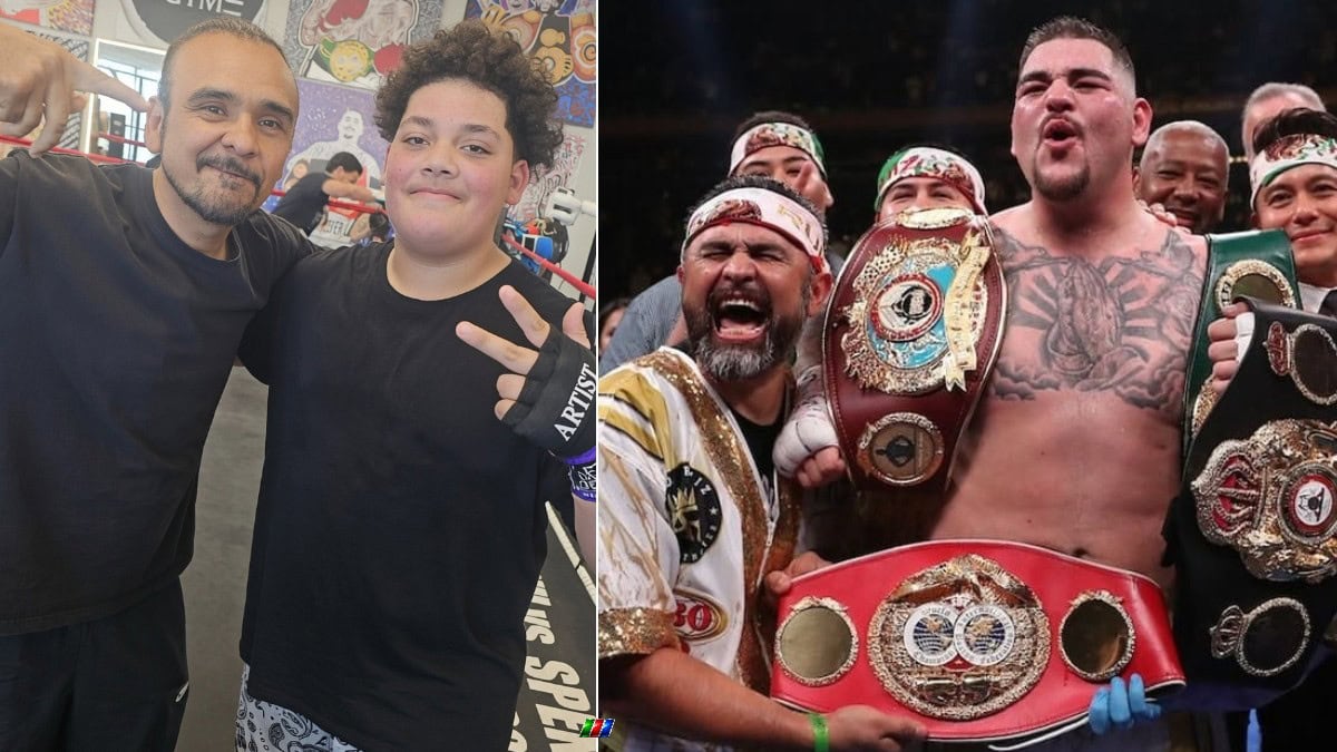 Andy Ruiz Jr poses with his son at a boxing gym alongside a photo of Ruiz celebrating his heavyweight title victory over Anthony Joshua