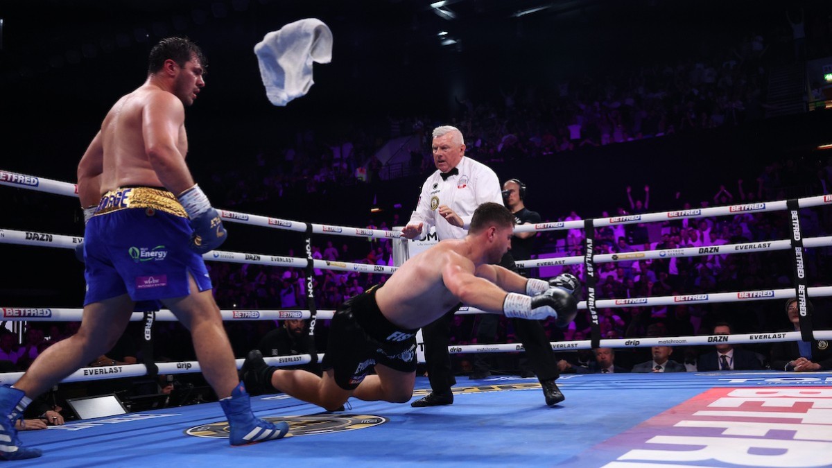Johnny Fisher falls to the canvas as Dave Allen stands nearby during their heavyweight rematch