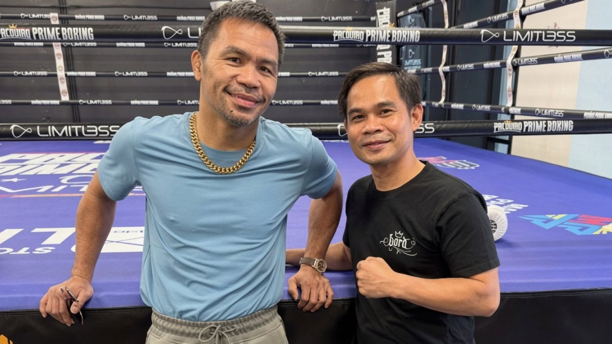 Manny Pacquiao poses with trainer Marvin Somodio during preparations for a planned September 2026 return and potential world title fight