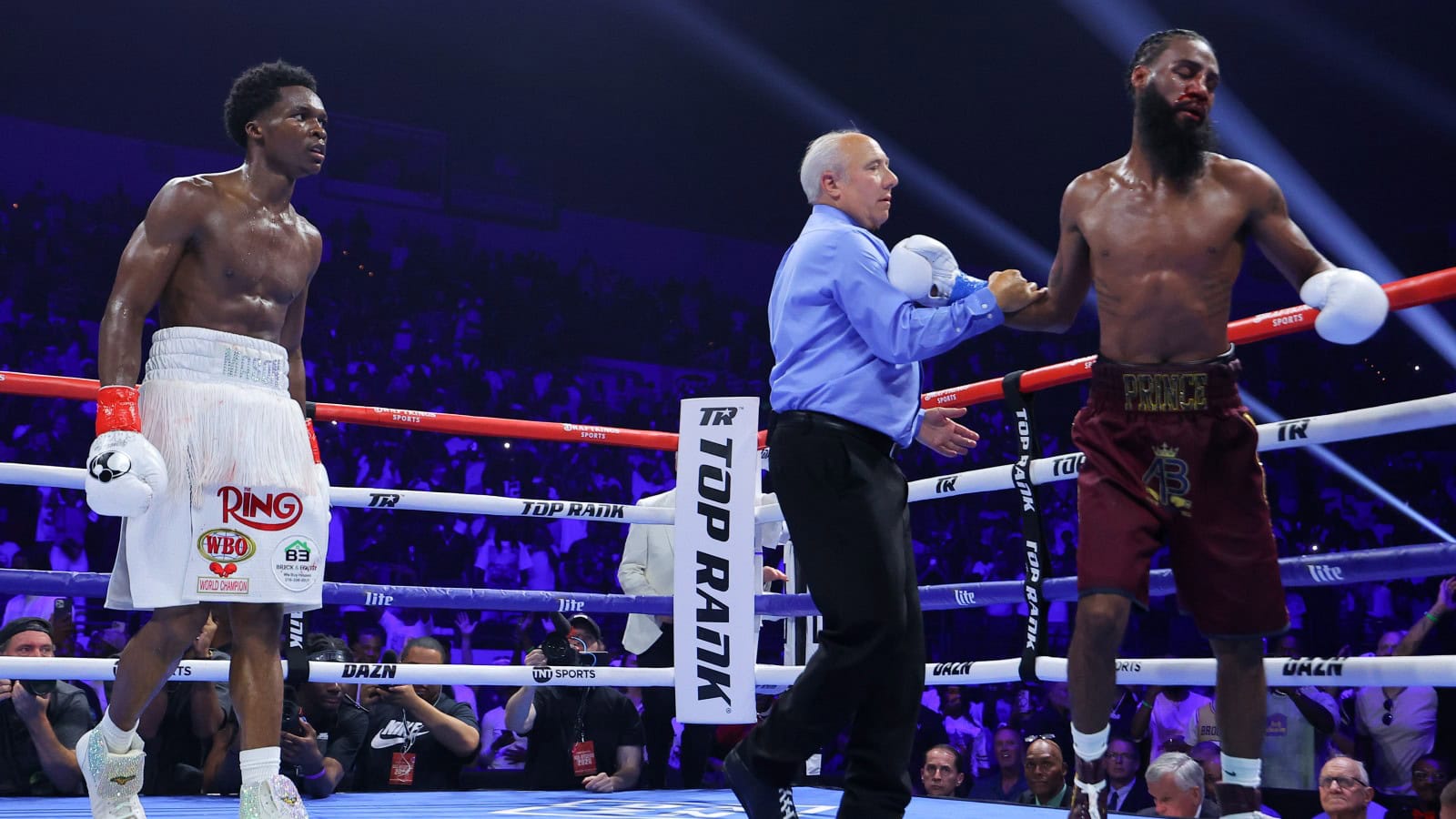 Abdullah Mason watches as referee Marc Nelson stops his WBO lightweight title fight against Albert Bell in the 12th round