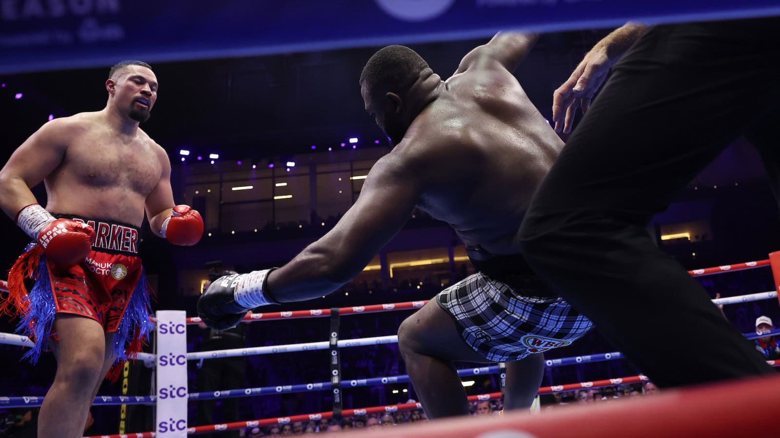 Martin Bakole falls toward the ropes after being dropped by Joseph Parker during their heavyweight fight
