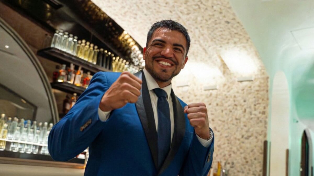 Victor Ortiz poses in a blue suit after explaining why he left professional boxing to join Bare Knuckle Boxing (BKB)