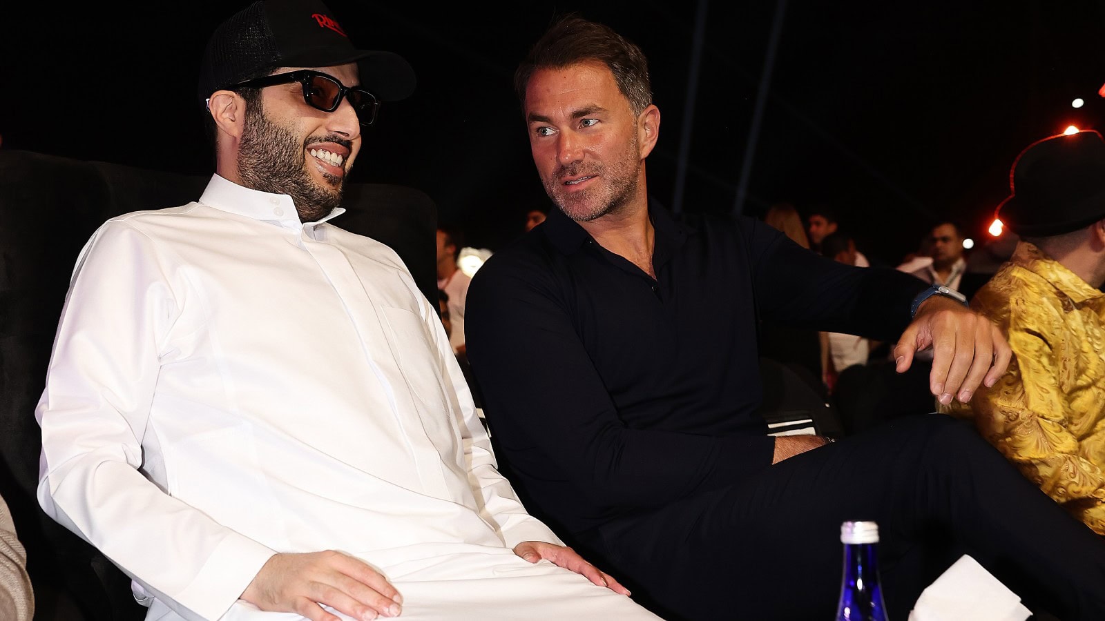 Turki Alalshikh and Eddie Hearn talk while seated ringside at a Riyadh Season boxing event