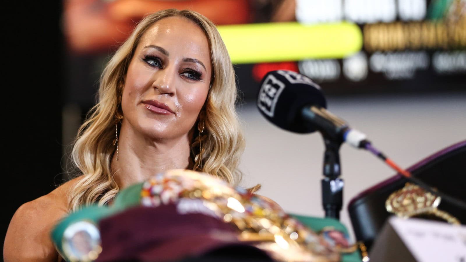 Kaye Scott speaks at a press conference with her WBC and WBA middleweight championship belts ahead of her title fight against Claressa Shields