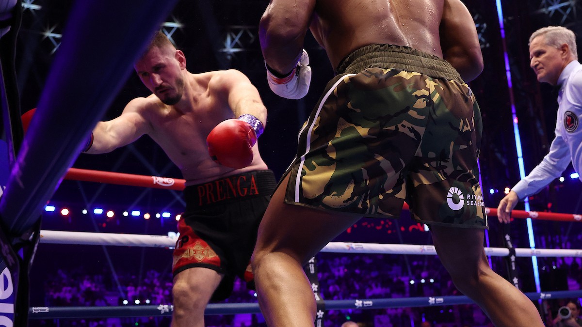 Anthony Joshua attacks Kristian Prenga after recovering from an opening-round knockdown during their heavyweight fight at the Jeddah Superdome in Saudi Arabia