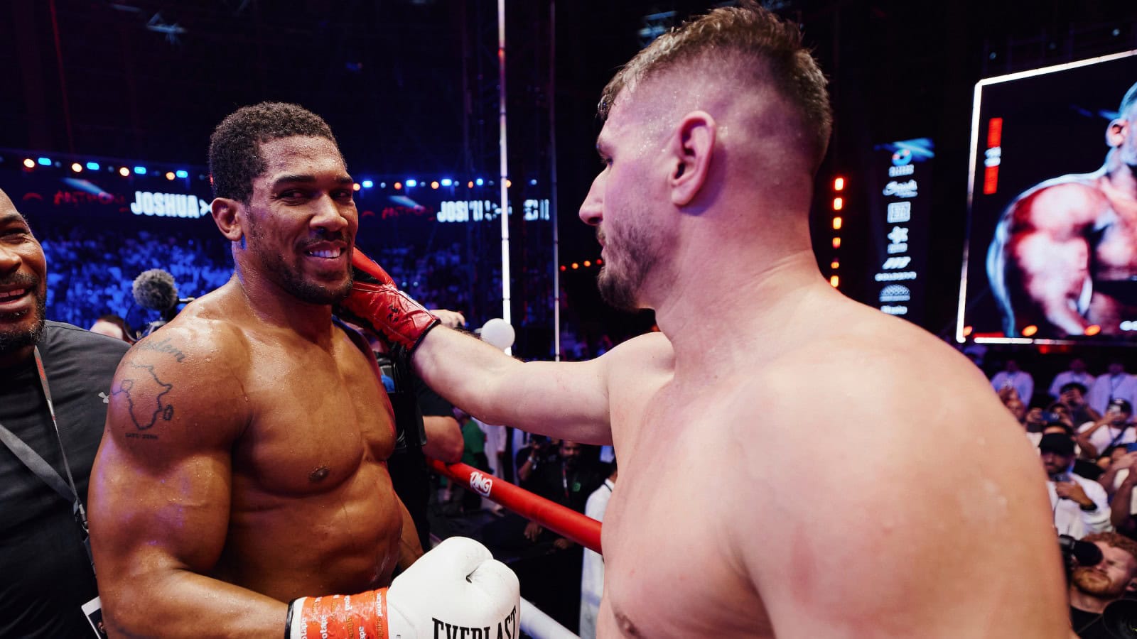Anthony Joshua and Kristian Prenga embrace after their heavyweight fight in Saudi Arabia