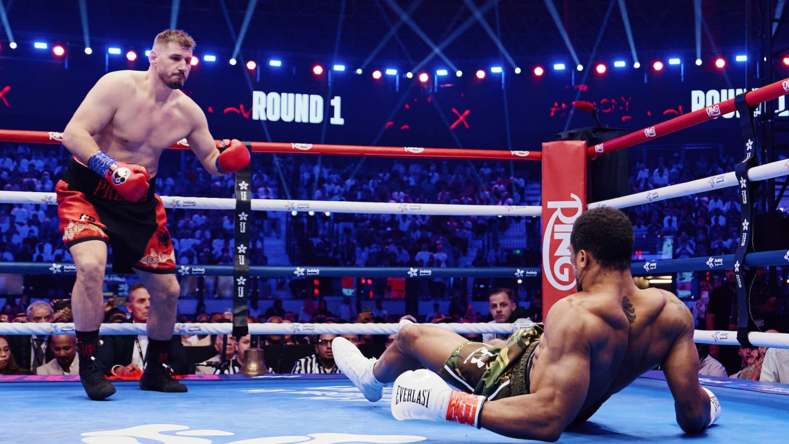 Kristian Prenga stands over Anthony Joshua after dropping the former heavyweight champion during the first round of their fight in Jeddah