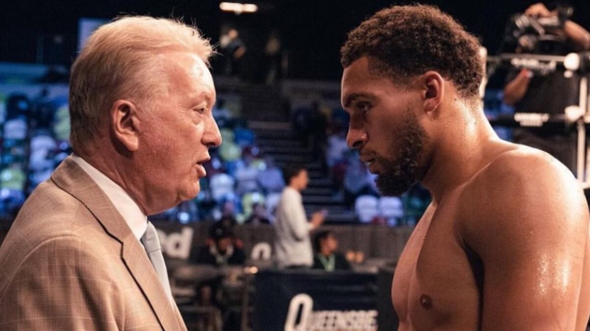Karol Itauma speaks with promoter Frank Warren during his boxing career