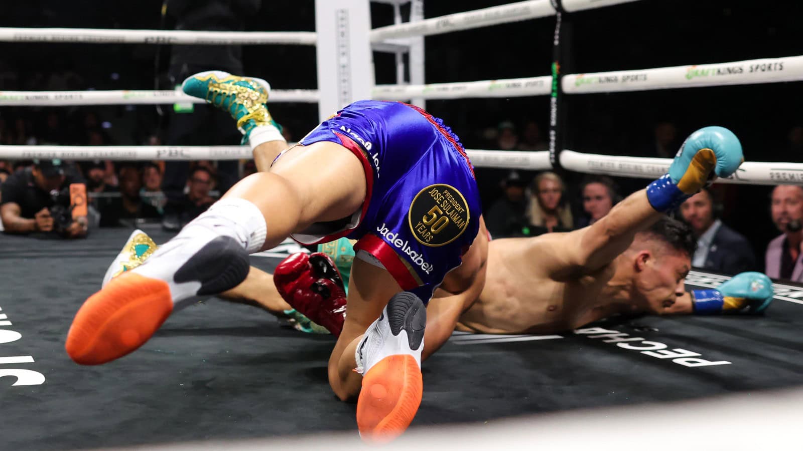Isaac Cruz and Nestor Bravo tumble to the canvas during their WBC interim super lightweight title fight