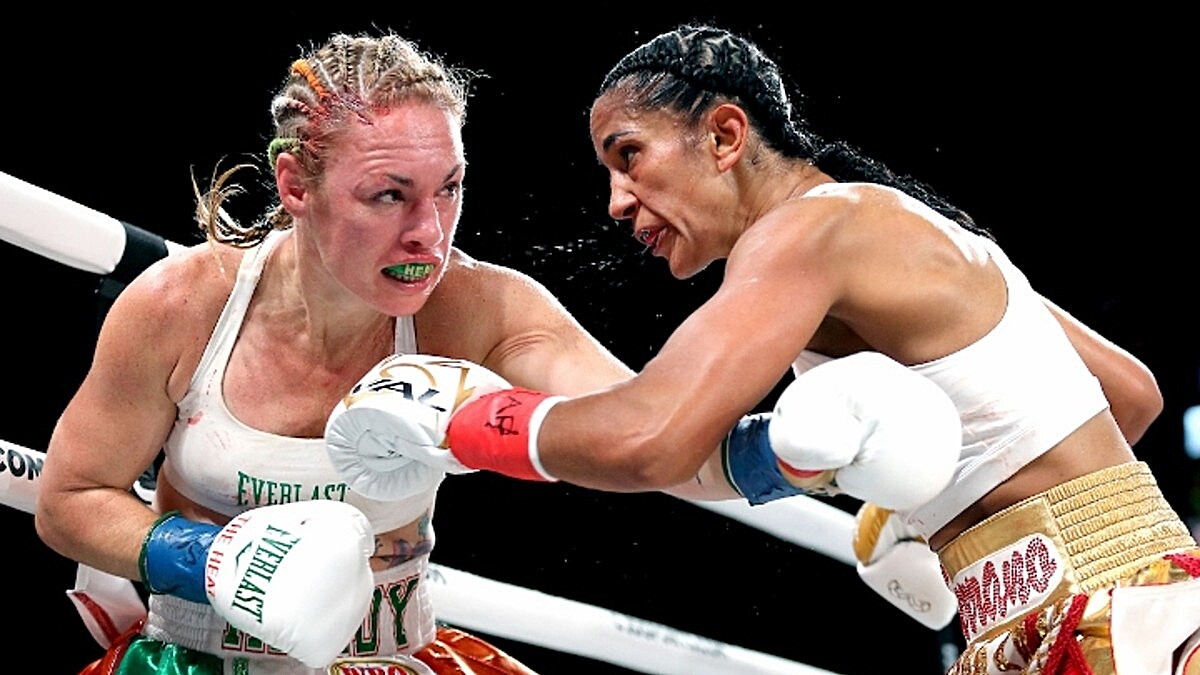 Heather Hardy takes a punch from Amanda Serrano during their 2023 undisputed featherweight title fight