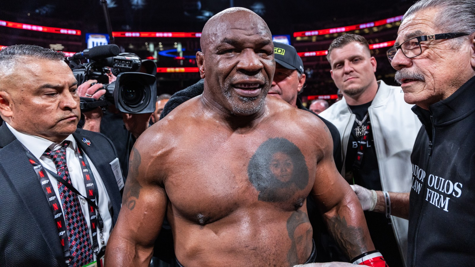 Mike Tyson surrounded by his team after losing to Jake Paul in November 2024