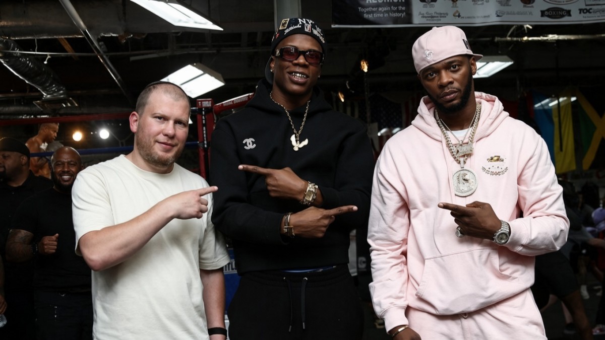 Promoter Dmitriy Salita, unbeaten light heavyweight Atif Oberlton and rapper Papoose pose together inside a boxing gym