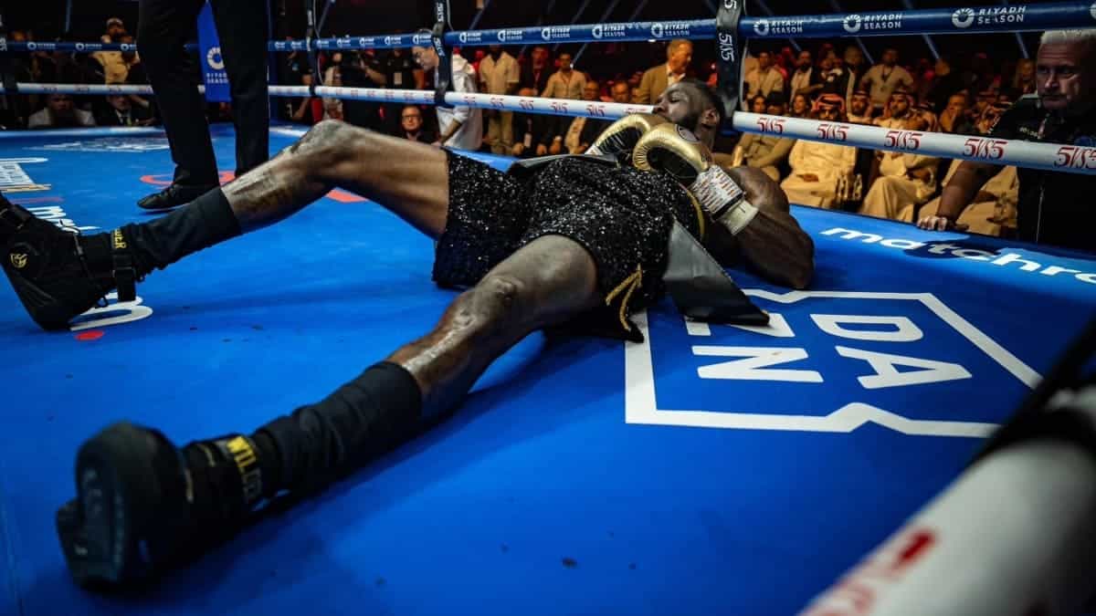 Deontay Wilder lies on the canvas after being knocked out by Zhilei Zhang in their heavyweight fight