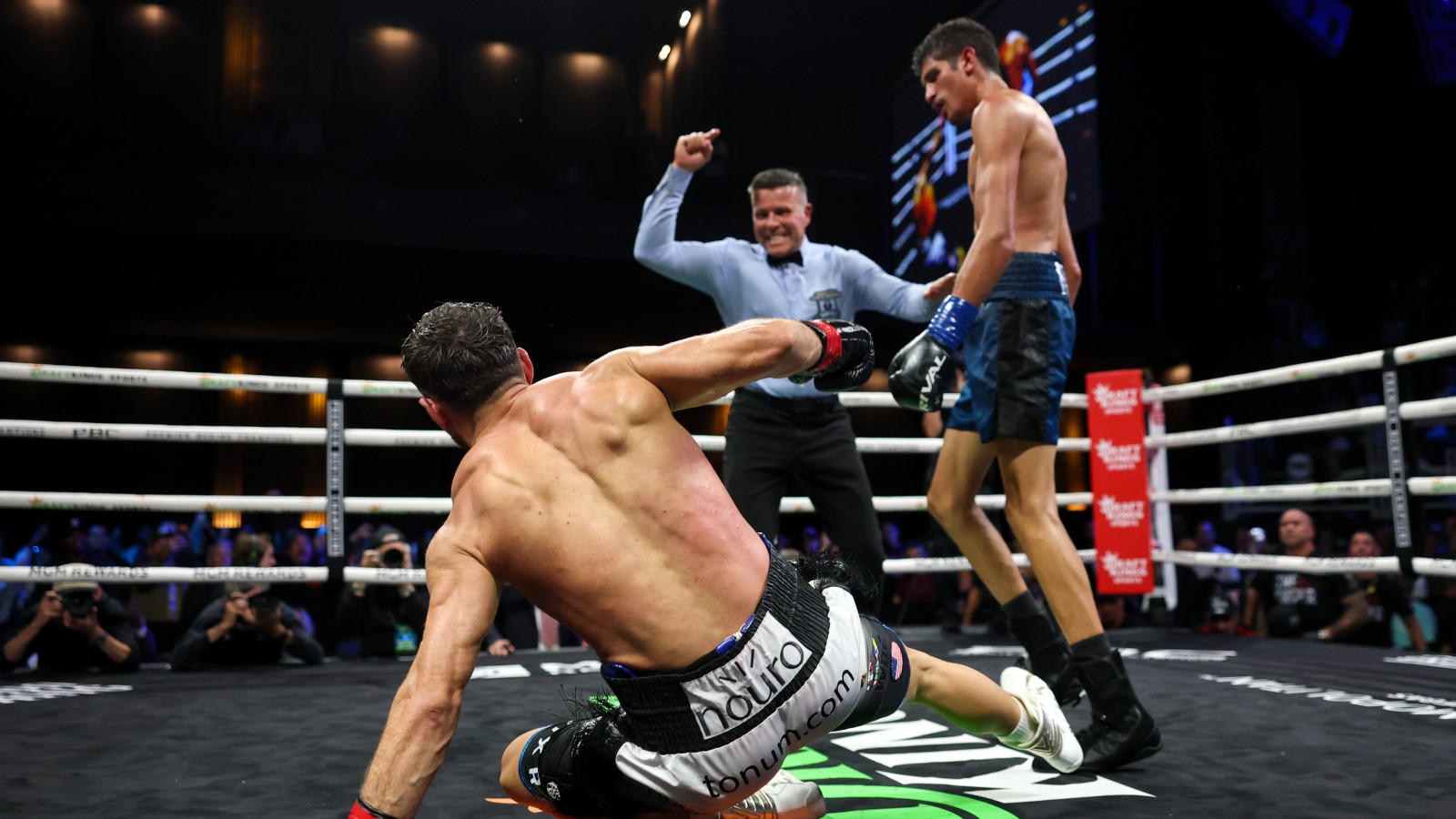 Sebastian Fundora stands over Ermal Hadribeaj as referee Thomas Taylor intervenes during their controversial WBC super welterweight title fight